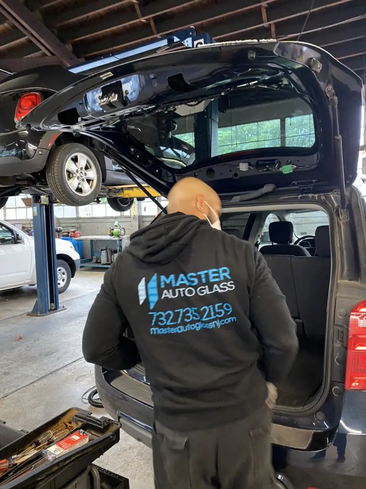 A technician calibrates automotive glass at Master Auto Glass, specializing in auto services in Wall Township.